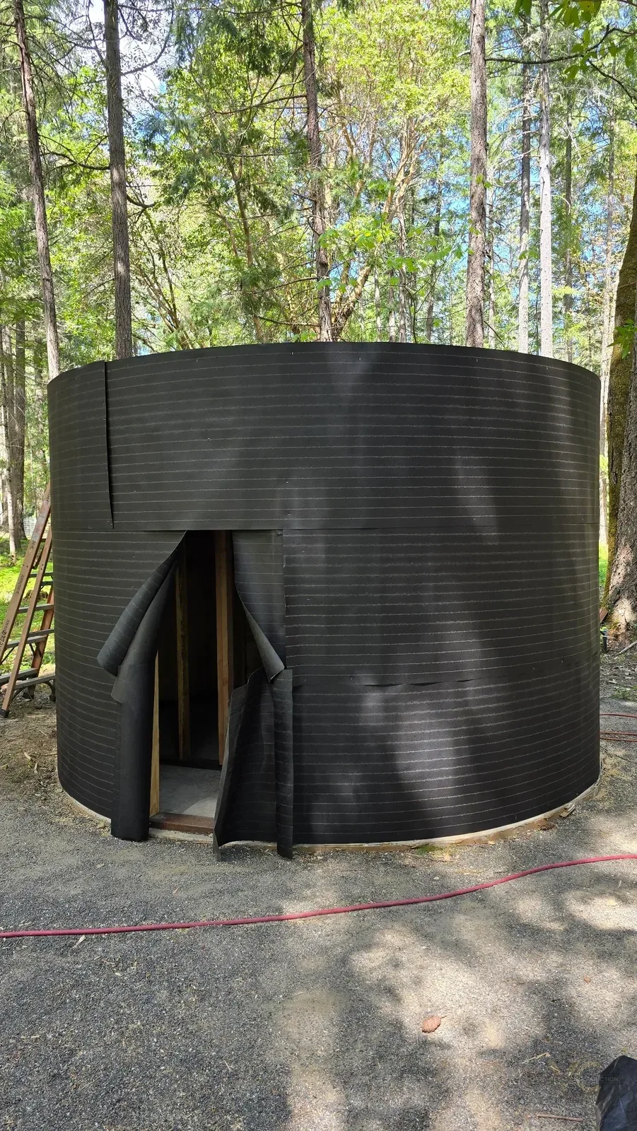 Curved round sauna shell covered with exterior moisture barrier during construction in the Applegate Valley