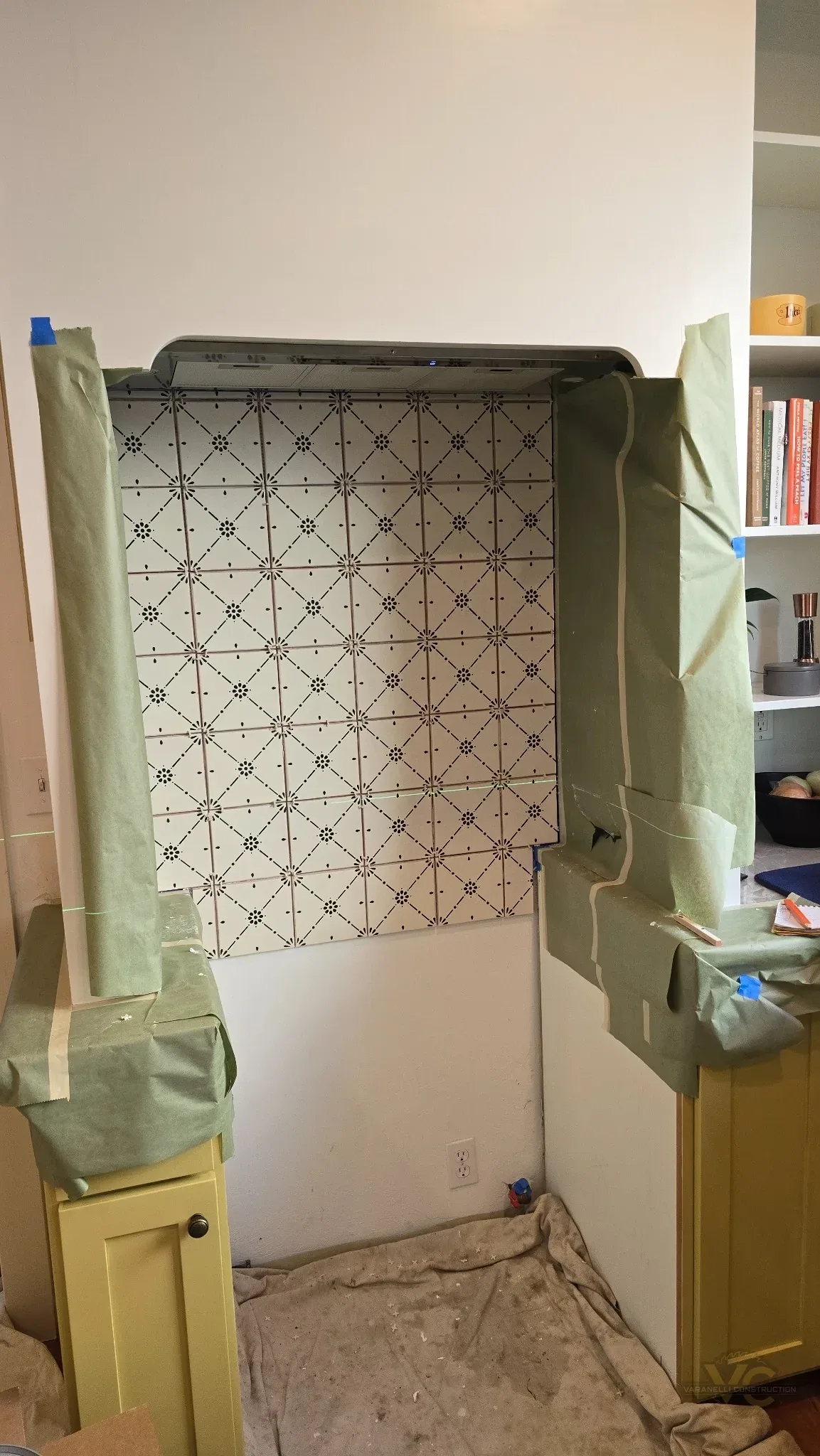 Patterned tile backsplash being installed in the custom range alcove during an Ashland kitchen remodel