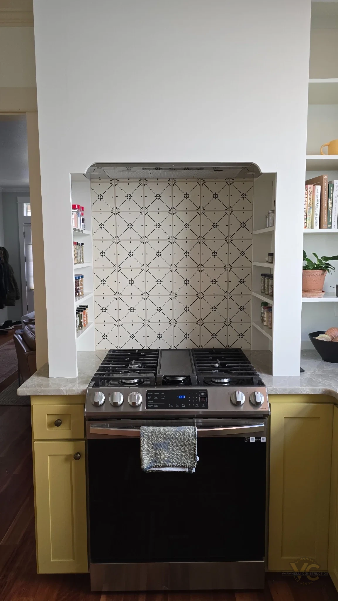 Finished Ashland range alcove with custom side shelving and patterned tile backsplash