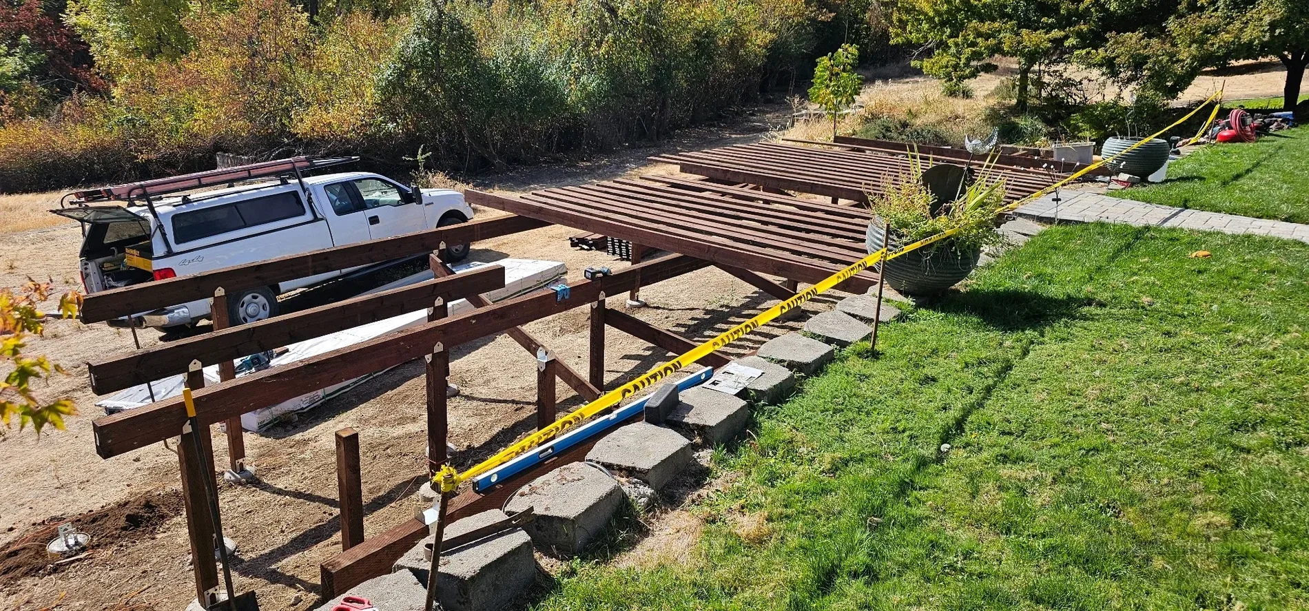 Concrete footings, posts and early pressure-treated deck framing on a sloped Gold Hill property