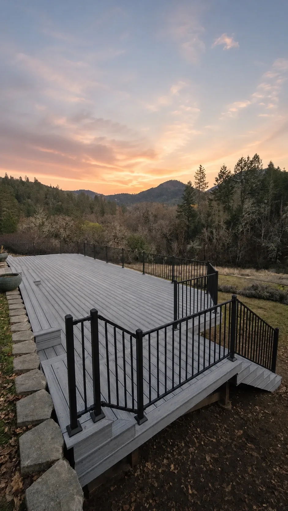 Completed Gold Hill Trex deck and black metal railing overlooking the hills at sunset
