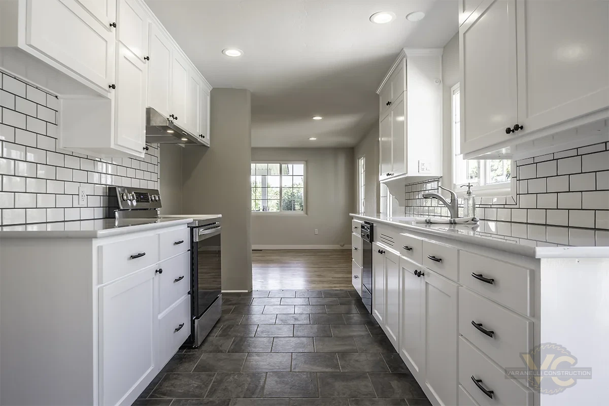 Finished white kitchen remodel in Grants Pass viewed toward adjacent living area