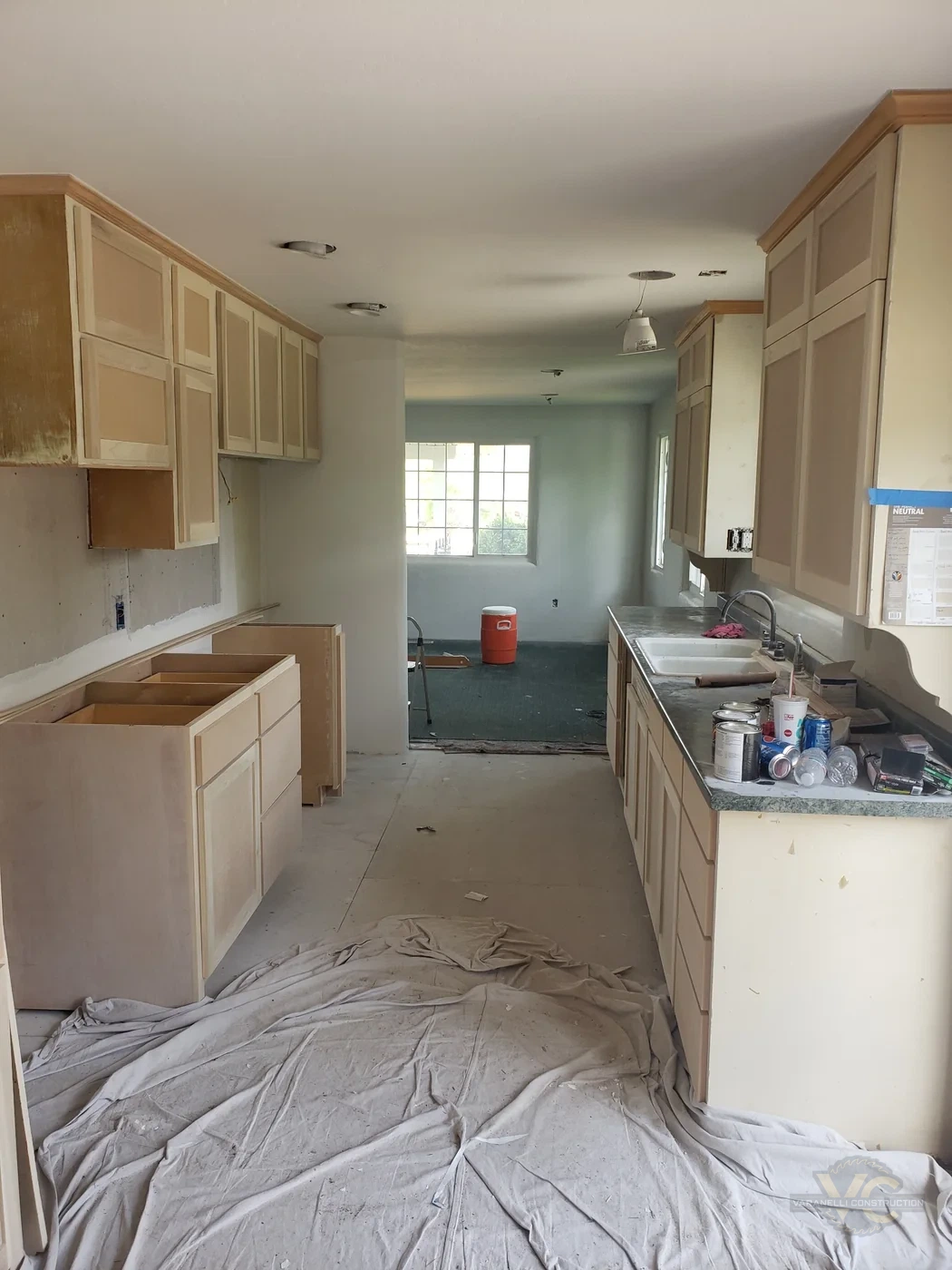 Kitchen remodel progress with cabinet refinishing and wall preparation in Grants Pass