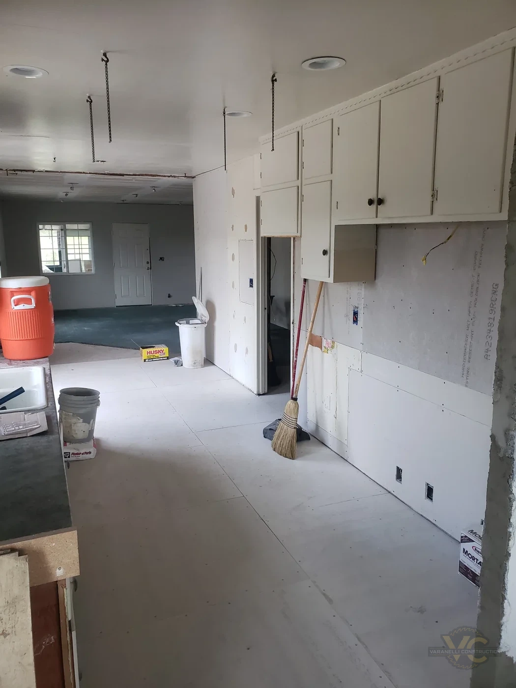 Grants Pass kitchen remodel in progress with wall repairs, floor underlayment and existing cabinets