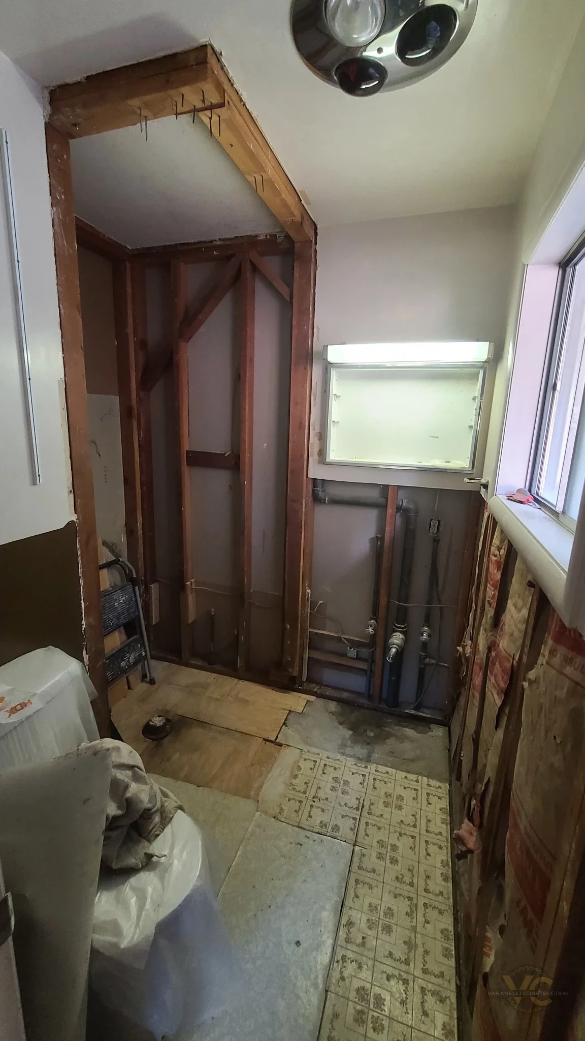 Small Grants Pass bathroom opened to wall framing and plumbing during remodeling