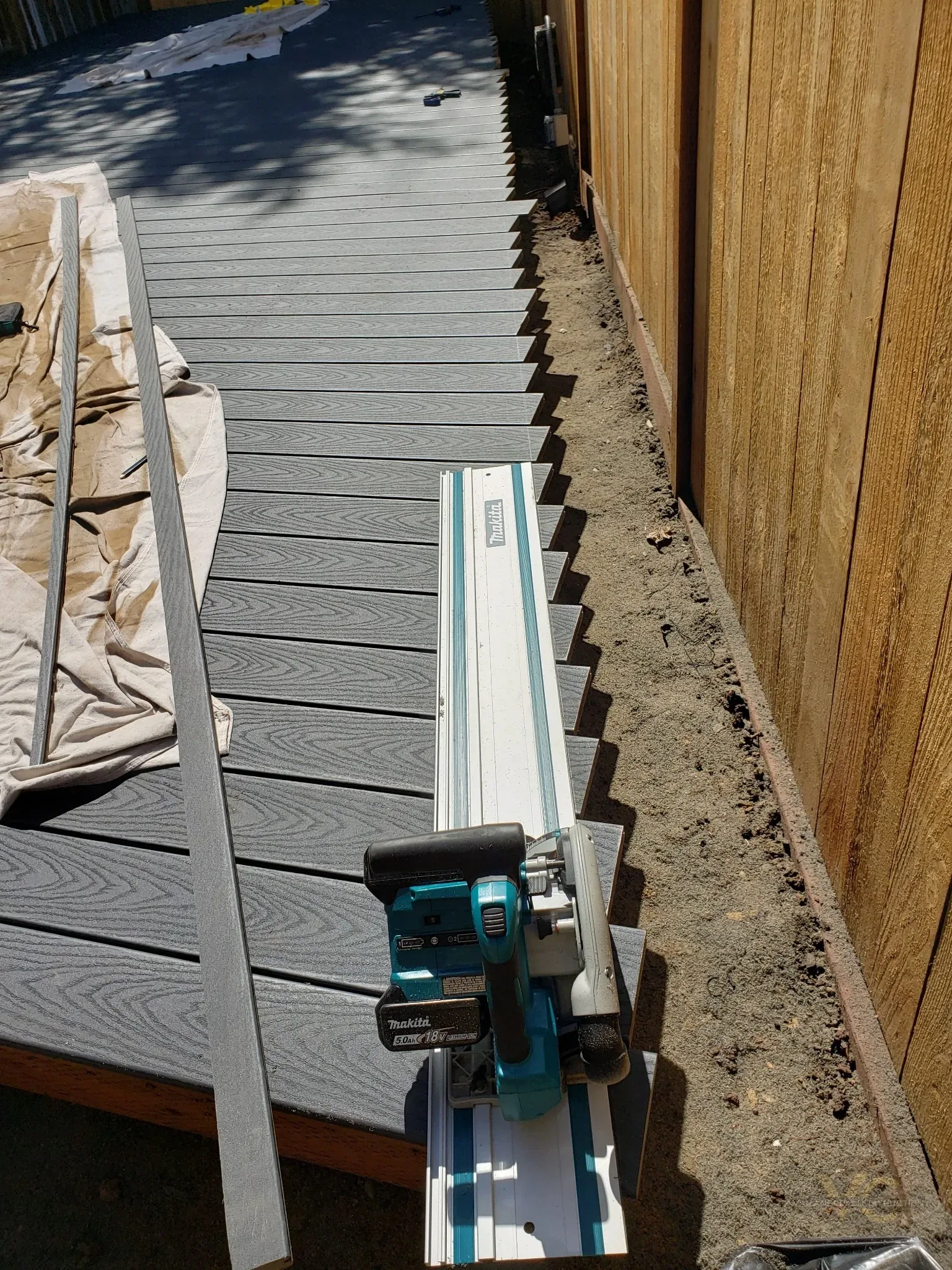 Trex composite deck boards being trimmed during installation on a Medford deck replacement