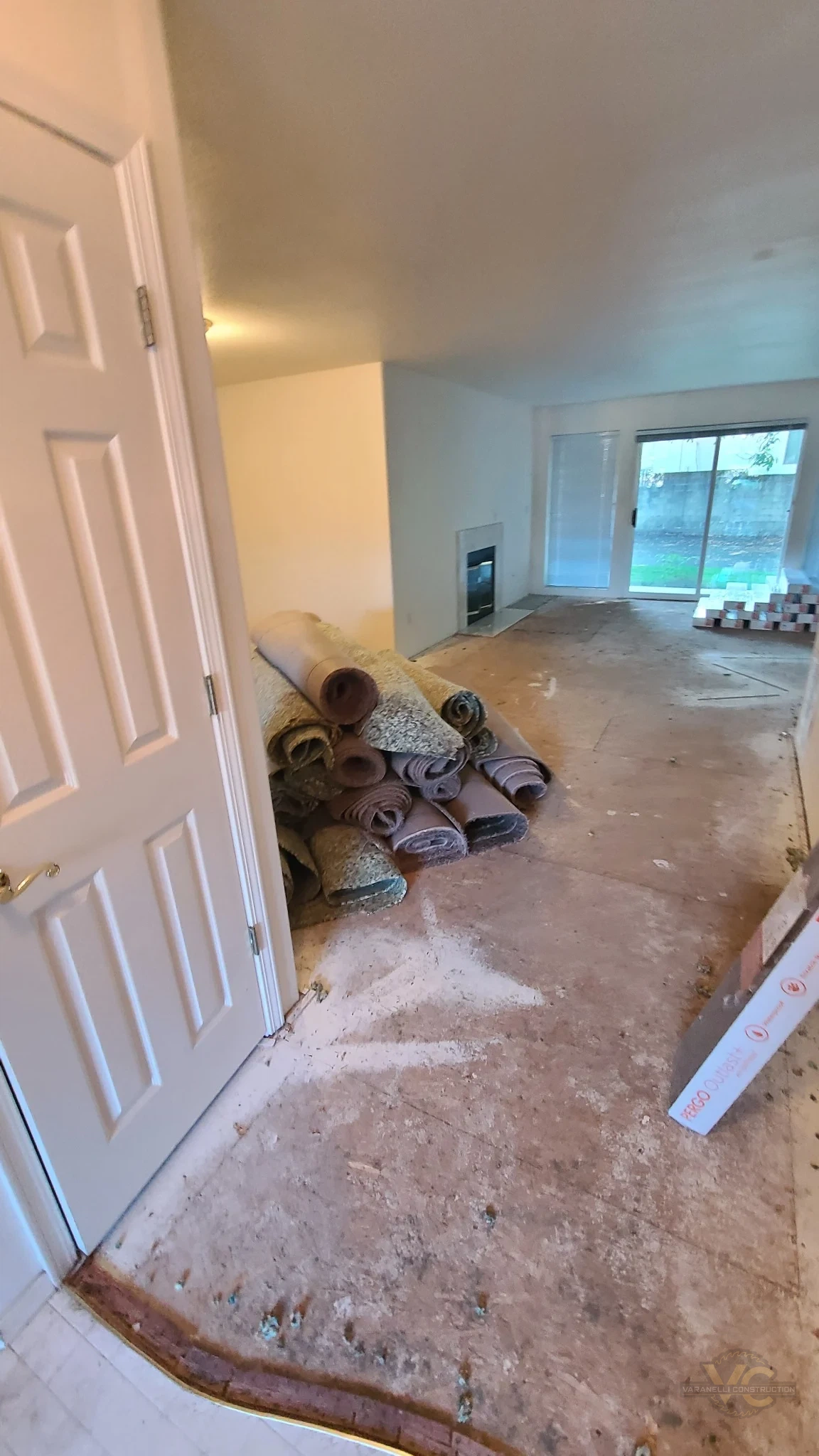 Old carpet removed and rolled up during a whole-house flooring project in Rogue River