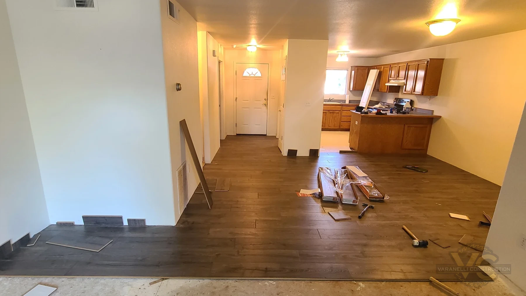 Laminate flooring installation in progress across an open-plan Rogue River home