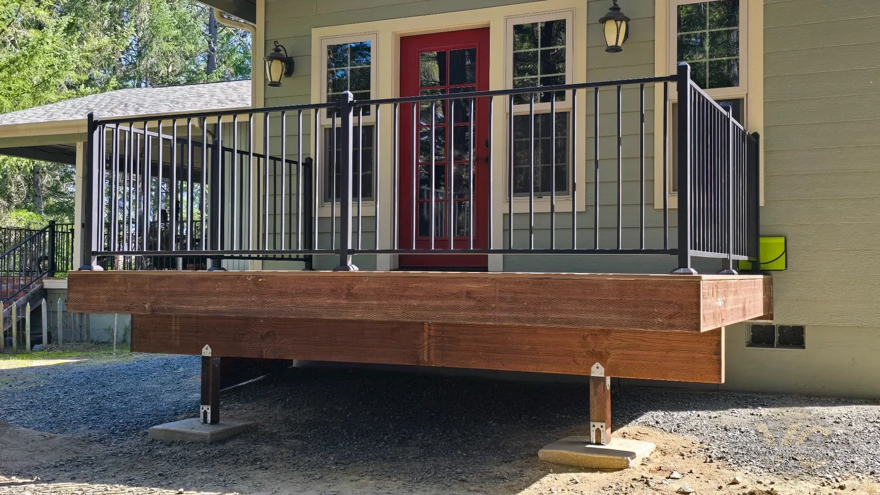 Trex composite decking and black powder-coated metal railing installed on Rogue River deck