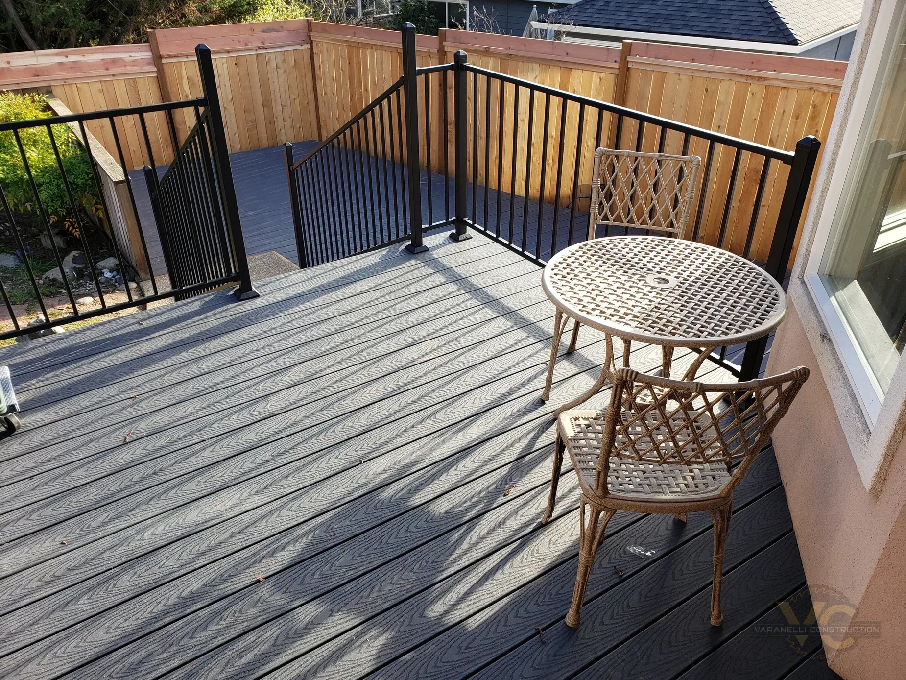 Composite deck with black railing by Varanelli Construction