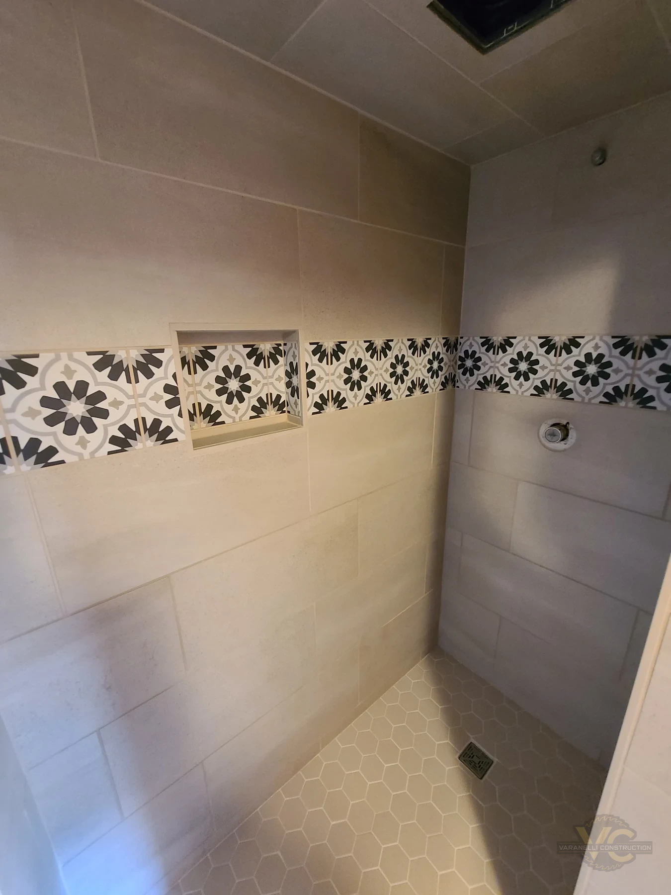 Decorative shower accent tile and large-format wall tile by Varanelli Construction