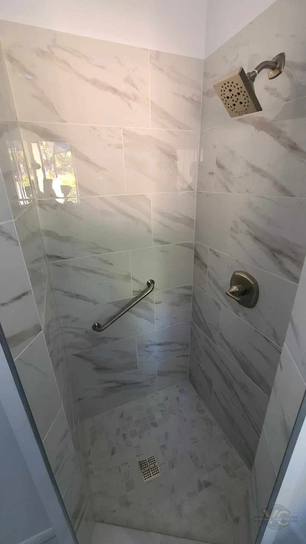 Marble-look tiled shower by Varanelli Construction