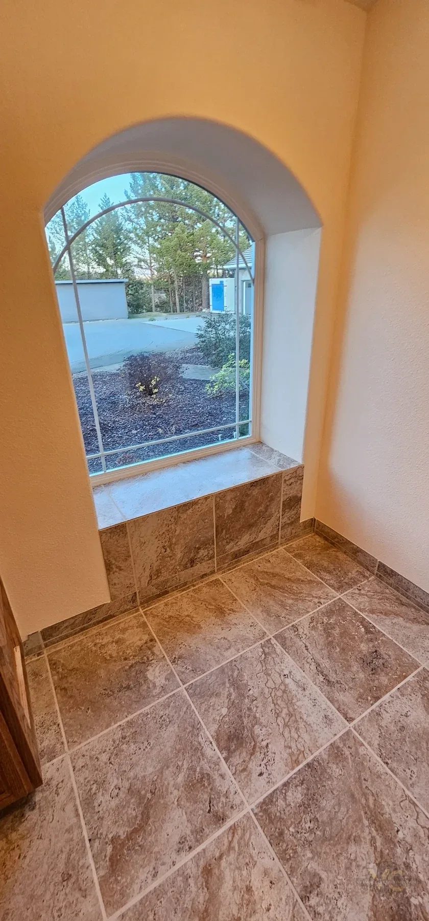 Large-format bathroom floor tile and tiled window detail by Varanelli Construction