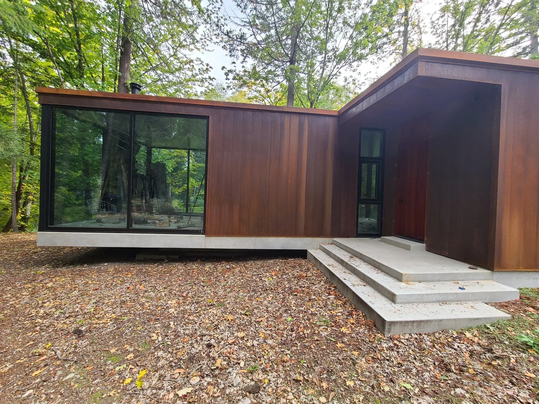 Exterior renovation with large window openings by Varanelli Construction